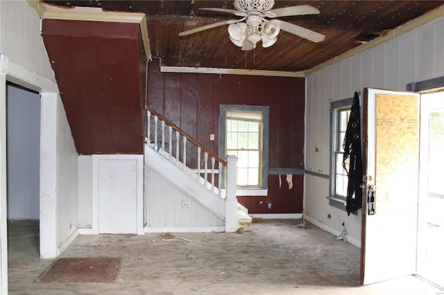 entryway with wood walls and ceiling fan