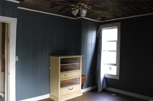 unfurnished bedroom with ceiling fan, hardwood / wood-style flooring, and ornamental molding