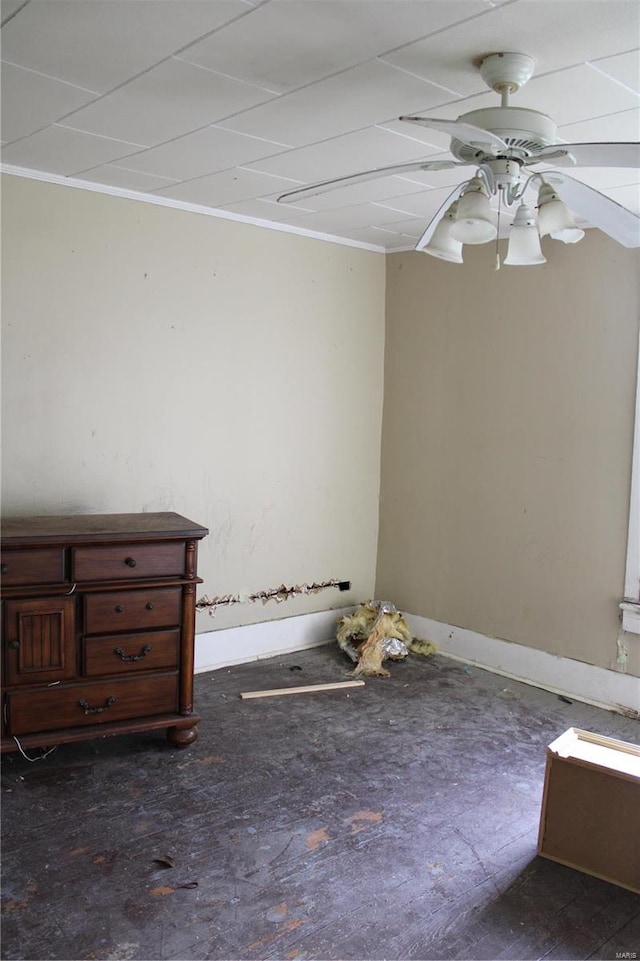 spare room featuring ceiling fan and ornamental molding