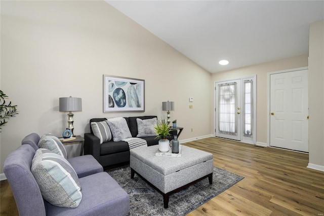 living room featuring dark wood-type flooring and vaulted ceiling