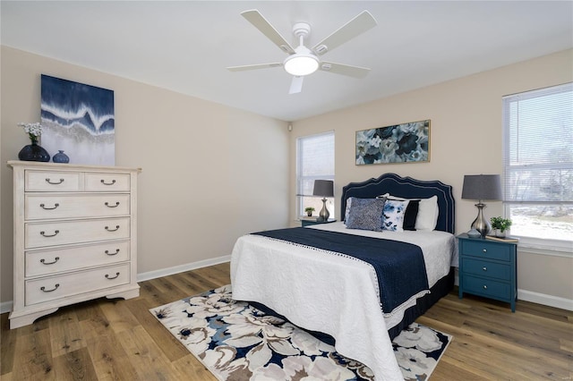 bedroom featuring multiple windows, light wood-type flooring, and ceiling fan