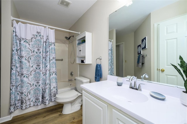 full bathroom with hardwood / wood-style flooring, vanity, toilet, and shower / bath combo with shower curtain