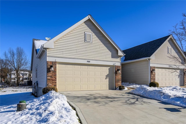 view of snow covered exterior with a garage