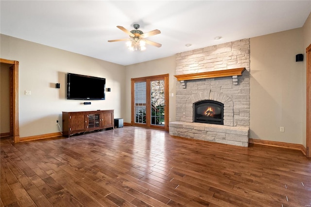 unfurnished living room featuring ceiling fan, dark hardwood / wood-style flooring, and a fireplace