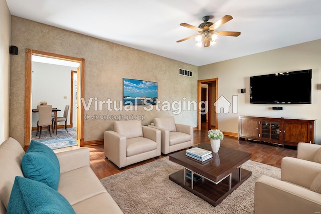 living room with hardwood / wood-style floors and ceiling fan