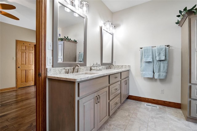 bathroom with ceiling fan and vanity