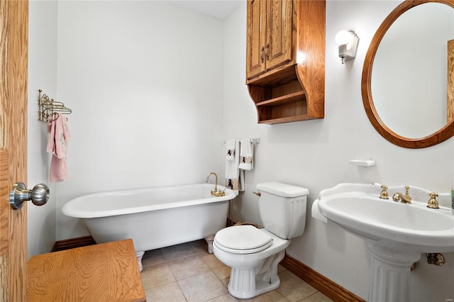 bathroom with a tub to relax in, toilet, and tile patterned flooring