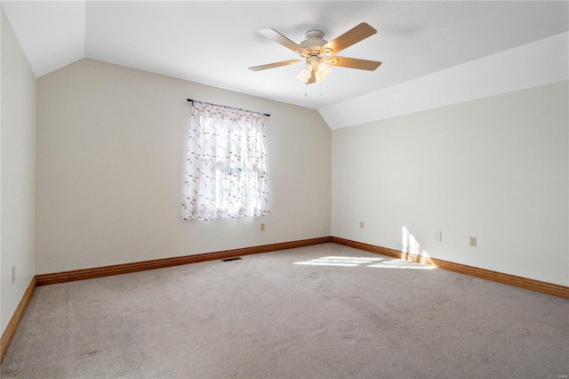 carpeted empty room with lofted ceiling and ceiling fan