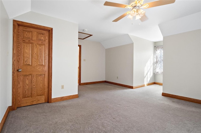 carpeted empty room with vaulted ceiling and ceiling fan