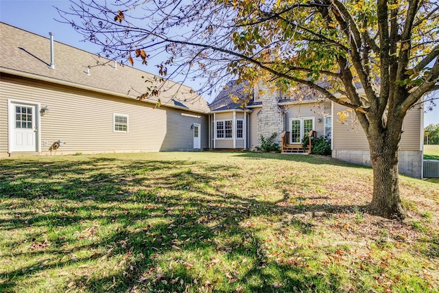 back of house with a lawn