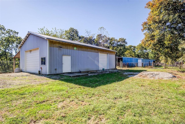 view of outdoor structure with a garage and a yard