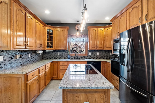 kitchen featuring light tile patterned flooring, sink, hanging light fixtures, decorative backsplash, and black appliances