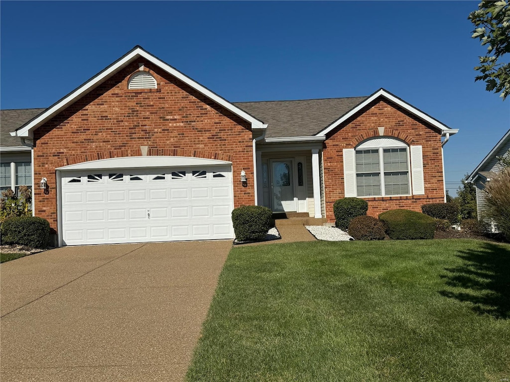 single story home featuring a front yard and a garage