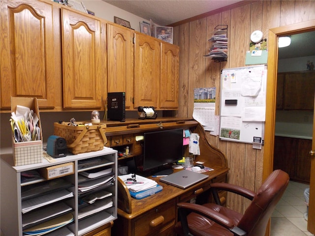 tiled office featuring wood walls and a textured ceiling