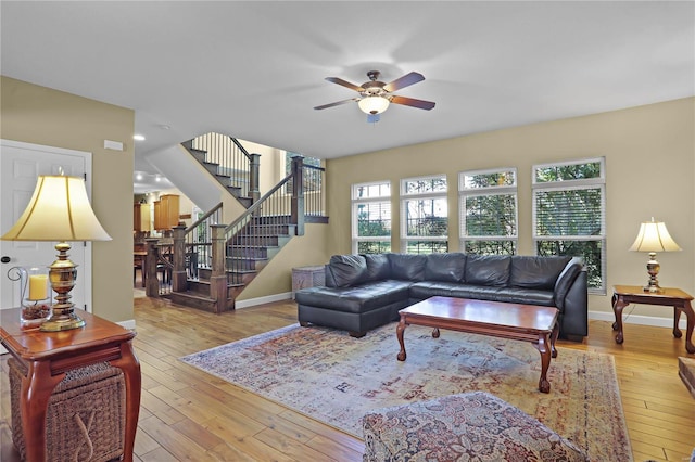 living room with light hardwood / wood-style floors and ceiling fan