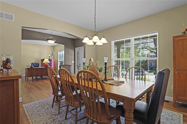 dining space with a chandelier and hardwood / wood-style floors