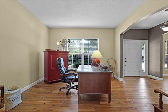 office featuring wood-type flooring and a textured ceiling