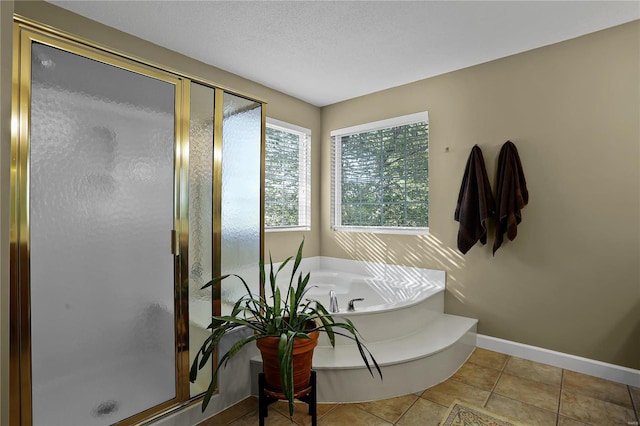 bathroom featuring shower with separate bathtub, tile patterned flooring, and a textured ceiling