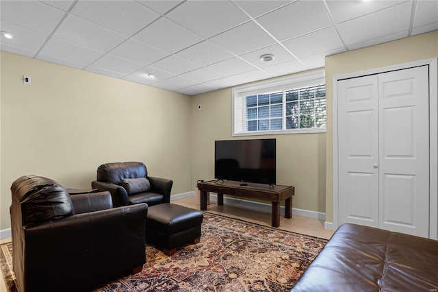 tiled living room with a drop ceiling