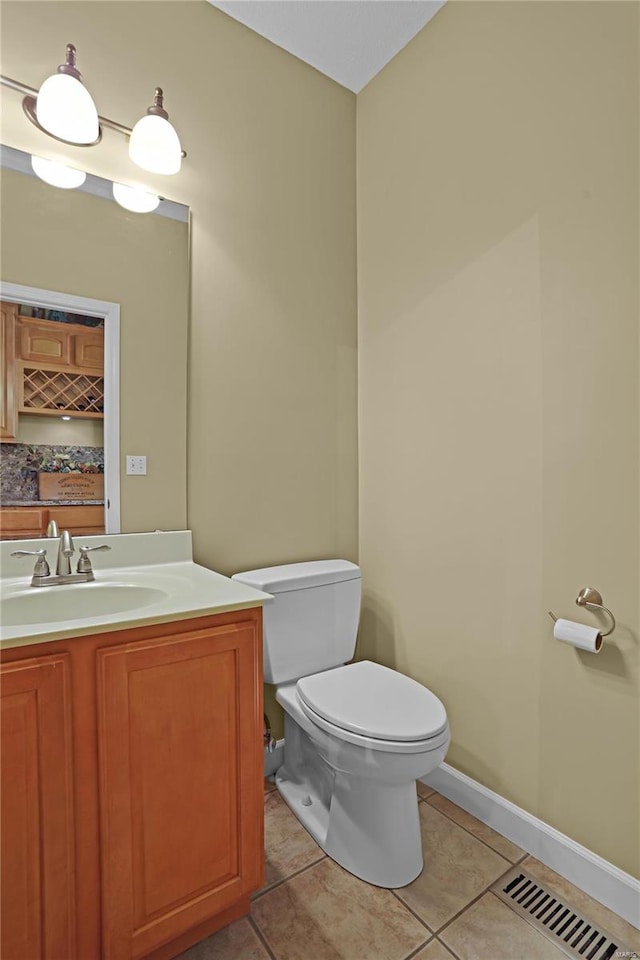 bathroom with vanity, tile patterned flooring, and toilet