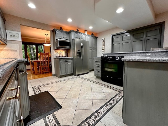 kitchen featuring appliances with stainless steel finishes, gray cabinetry, light tile patterned flooring, and tasteful backsplash