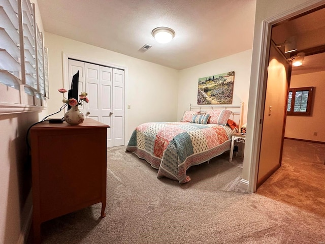 bedroom with a closet and carpet floors