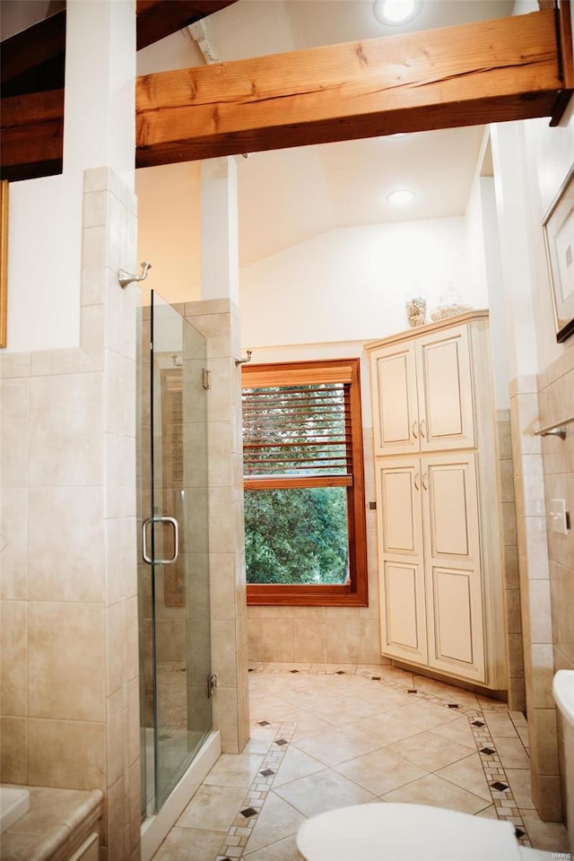 bathroom featuring vaulted ceiling with beams, tile walls, a shower with door, and tile patterned floors