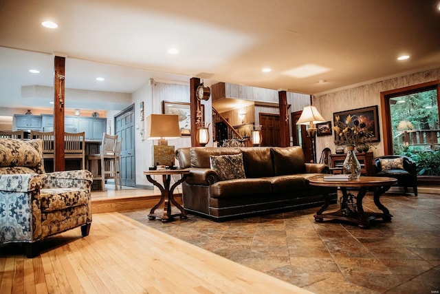 living room with hardwood / wood-style flooring and crown molding