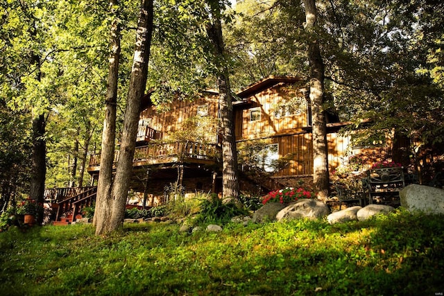 rear view of property featuring a wooden deck