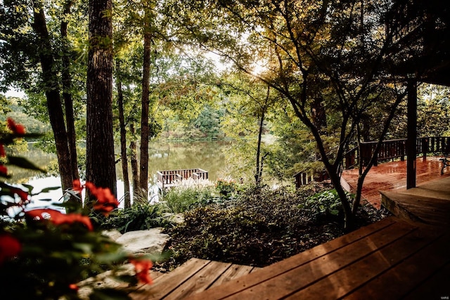 wooden terrace featuring a water view