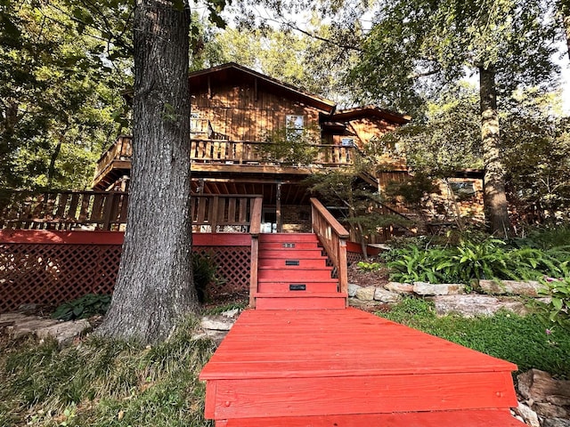 rear view of house featuring a deck