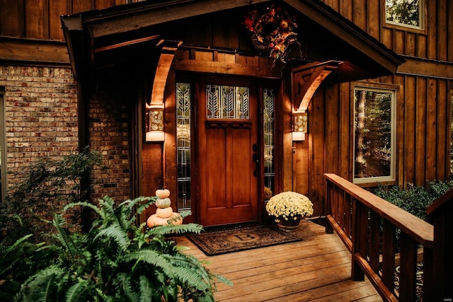 view of exterior entry with a deck