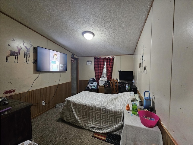 bedroom featuring carpet floors, a textured ceiling, wood walls, and vaulted ceiling