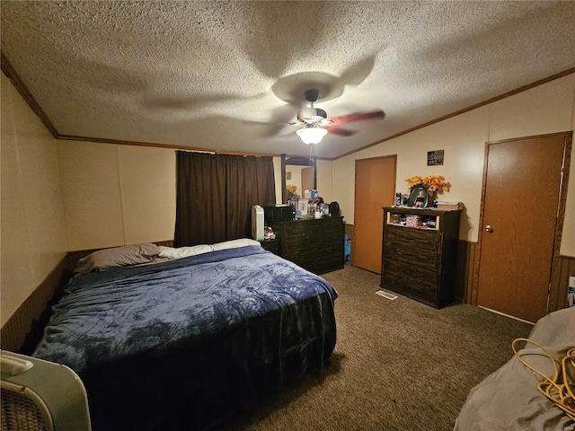 bedroom featuring a textured ceiling, vaulted ceiling, carpet, crown molding, and ceiling fan