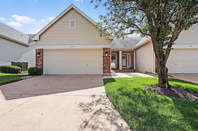 view of front of home with a garage and a front lawn