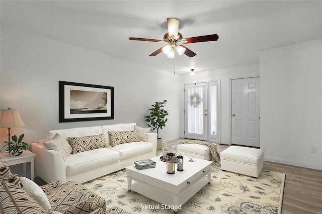 living room with light hardwood / wood-style flooring and ceiling fan