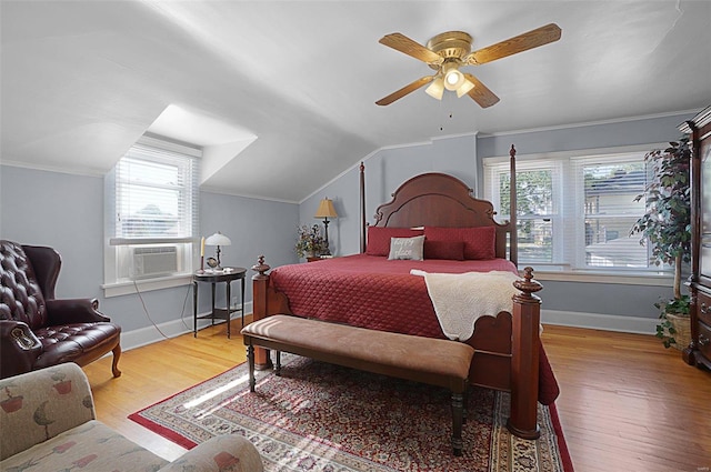 bedroom with cooling unit, vaulted ceiling, light hardwood / wood-style flooring, and ceiling fan