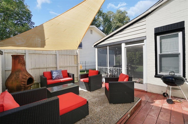 view of patio featuring a sunroom and a grill