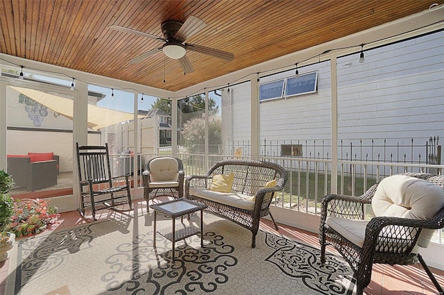 sunroom with wood ceiling and ceiling fan