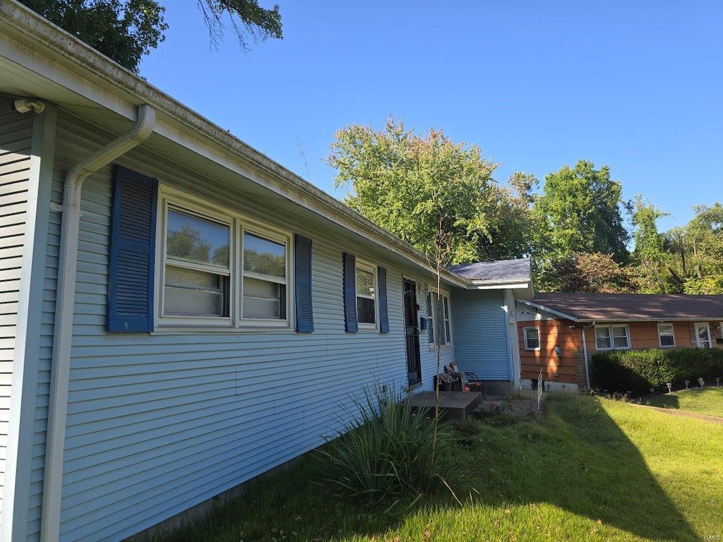 view of home's exterior with a lawn