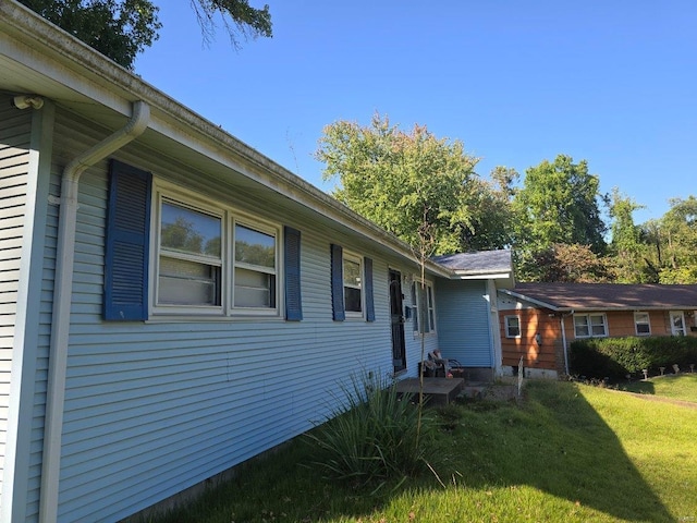 view of home's exterior with a lawn