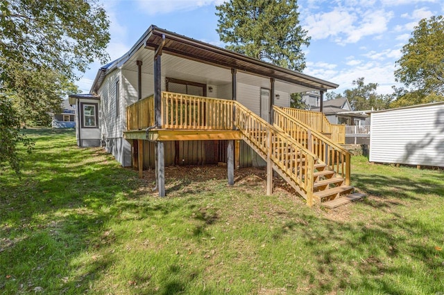 back of property featuring a lawn and a deck