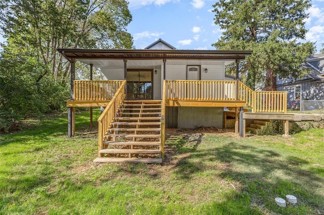 rear view of house featuring a yard