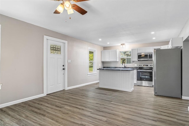 kitchen with white cabinetry, sink, dark wood-type flooring, and stainless steel appliances