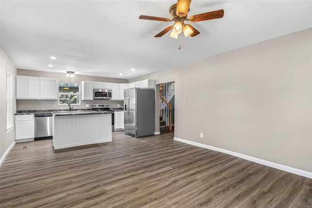 kitchen featuring sink, a kitchen island, dark wood-type flooring, white cabinetry, and appliances with stainless steel finishes