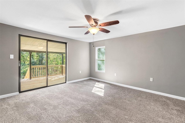 carpeted empty room with ceiling fan and a healthy amount of sunlight