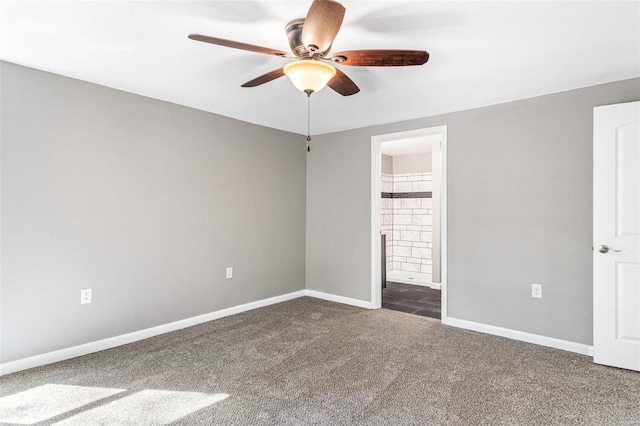 empty room with ceiling fan and dark colored carpet