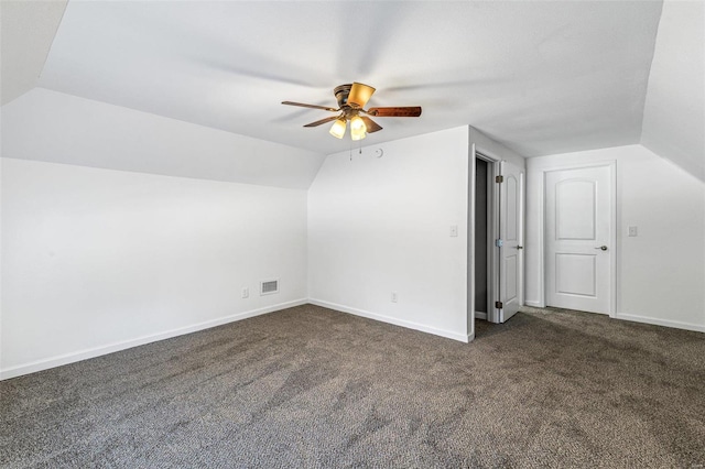 bonus room featuring ceiling fan, lofted ceiling, and dark colored carpet