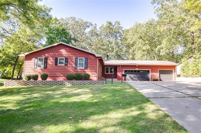 view of front of house with a front yard and a garage