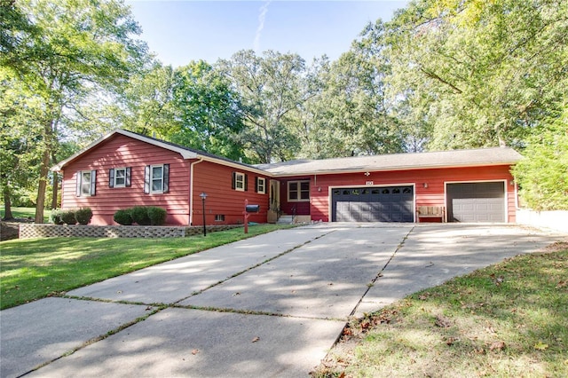 view of front of house with a front yard and a garage